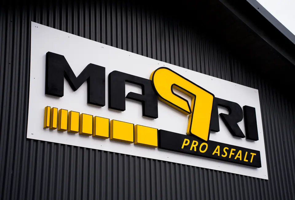 Non-illuminated branding sign in daylight