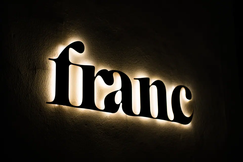 Franc lettering with a warm halo at night